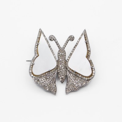 Lot 74 - A silver white metal mother-of-pearl and diamond set butterfly brooch.