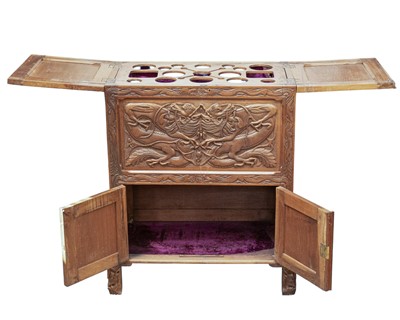 Lot 369 - A Chinese carved teak drinks or cocktail cabinet.