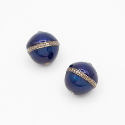 Lot 76 - A pair of dark blue enamel ovoid beads each set with a band of small diamonds.