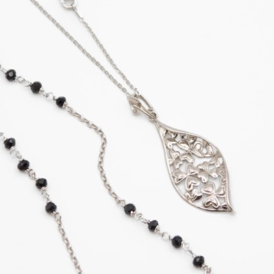 Lot 81 - A silver leaf-shaped pendant necklace, and a long silver black glass bead necklace with cross.