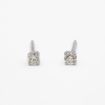 Lot 107 - A pair of 18k white gold diamond solitaire stud earrings.