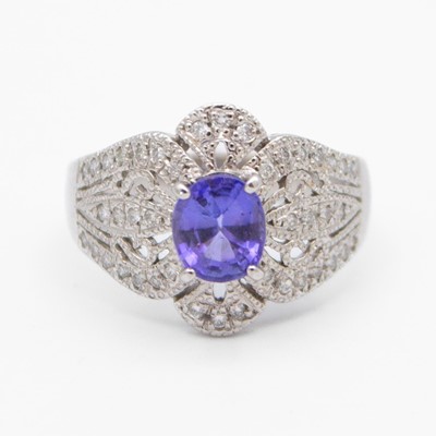 Lot 124 - A stylish platinum dress ring set with an oval tanzanite and diamonds.