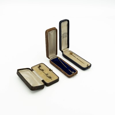 Lot 85 - A 15ct stick pin set with aquamarine and seed pearl, a gold pink paste pin and one other pin.