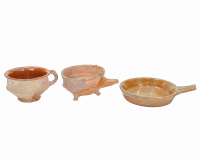 Lot 615 - A Dutch red earthenware pipkin type bowl.