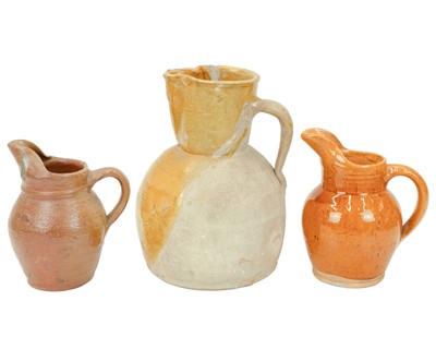 Lot 593 - A French mustard glaze terracotta jug.