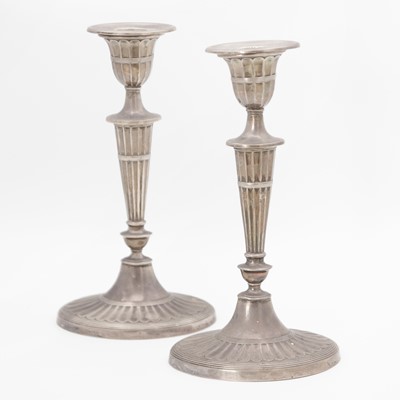 Lot 108 - A pair of Edwardian weighted silver candlesticks by William Hutton & Sons Ltd.