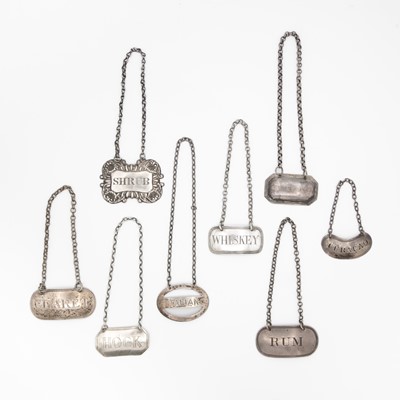 Lot 145 - A selection of eight silver wine labels.