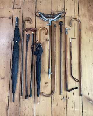 Lot 16 - Lanvin Parfums Umbrella together with walking canes etc