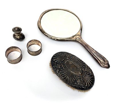 Lot 2047 - A silver hand mirror, a silver mounted brush,...