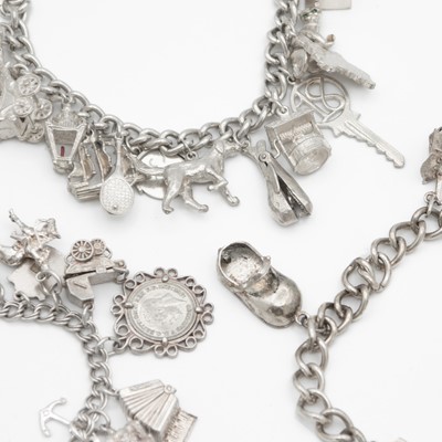 Lot 101 - A selection of three white metal and silver charm bracelets.