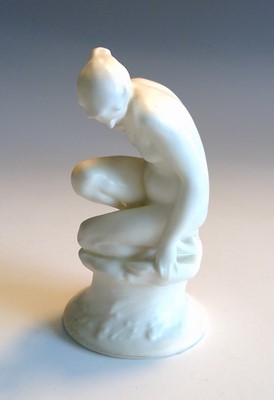 Lot 841 - A Royal Doulton figure of a crouching female...