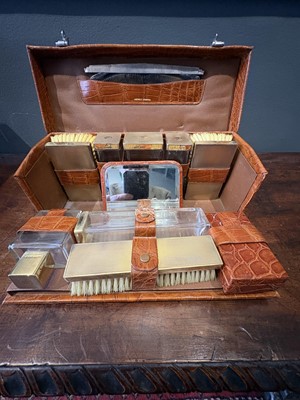 Lot 148 - An Asprey crocodile cased silver gilt mounted gentleman's dressing set.