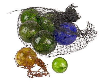 Lot 487 - A group of seven coloured glass fishing floats.