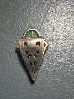 Lot 3 - An Art Deco rose gold green jadeite set dress clip.