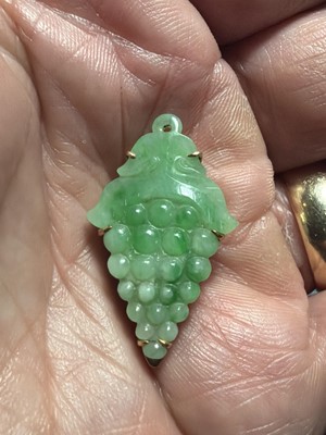 Lot 3 - An Art Deco rose gold green jadeite set dress clip.