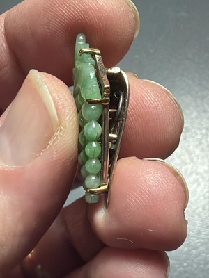 Lot 3 - An Art Deco rose gold green jadeite set dress clip.