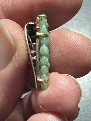 Lot 3 - An Art Deco rose gold green jadeite set dress clip.