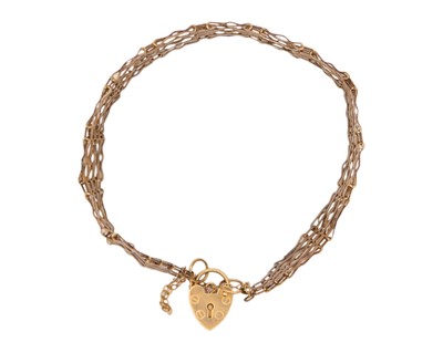 Lot 28 - A 9k five-bar gate bracelet with padlock clasp.
