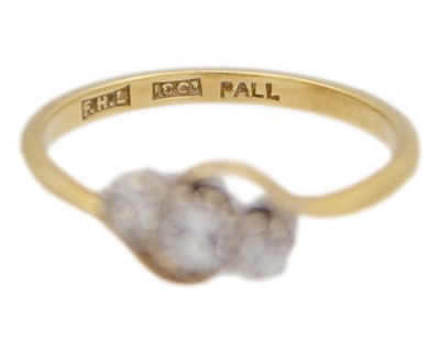 Lot 18 - An 18k and palladium white spinel set three-stone ring.