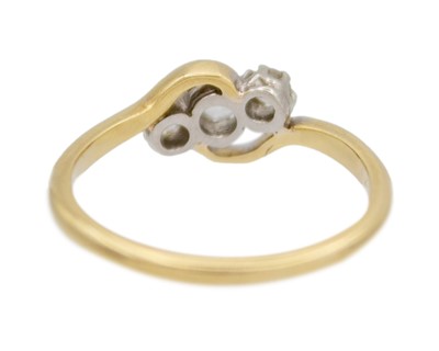 Lot 18 - An 18k and palladium white spinel set three-stone ring.