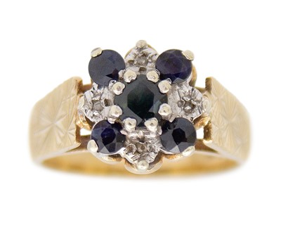 Lot 32 - A 9k blue sapphire and diamond set cluster ring.