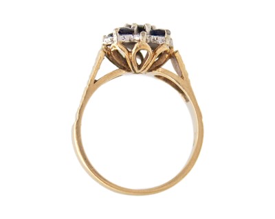 Lot 32 - A 9k blue sapphire and diamond set cluster ring.