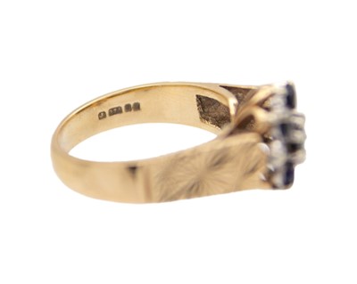 Lot 32 - A 9k blue sapphire and diamond set cluster ring.