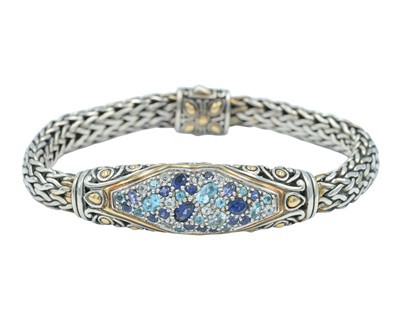 Lot 107 - JOHN HARDY - A 925 and 18k woven chain bracelet set with blue gemstones, within original box.