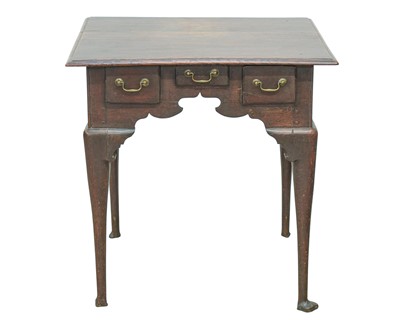 Lot 853 - A George III oak lowboy.