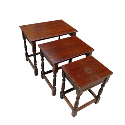 Lot 129 - A nest of Oak occasional tables. The largest...