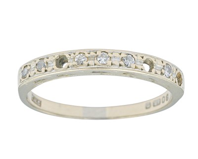 Lot 62 - A modern 18k white gold diamond set half eternity ring.