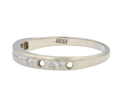 Lot 62 - A modern 18k white gold diamond set half eternity ring.