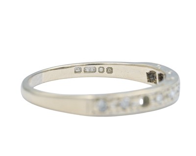Lot 62 - A modern 18k white gold diamond set half eternity ring.