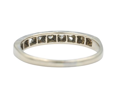 Lot 62 - A modern 18k white gold diamond set half eternity ring.