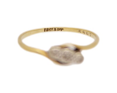 Lot 91 - An 18k and platinum diamond set three stone ring.
