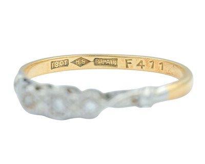 Lot 76 - An 18k and platinum diamond set three-stone ring.