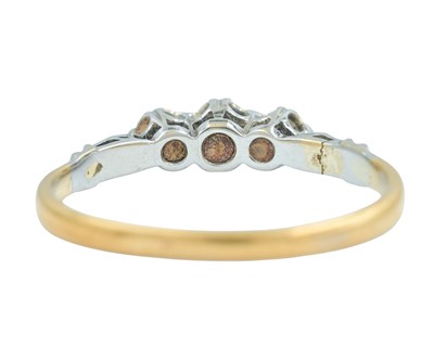 Lot 76 - An 18k and platinum diamond set three-stone ring.