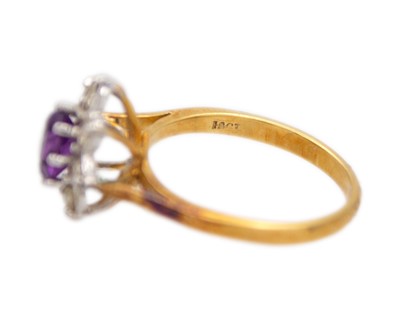 Lot 42 - An 18k amethyst and diamond set cluster ring.
