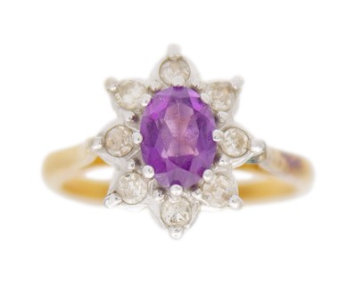 Lot 42 - An 18k amethyst and diamond set cluster ring.