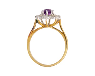 Lot 42 - An 18k amethyst and diamond set cluster ring.