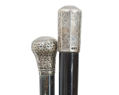 Lot 23 - A collection of walking sticks and canes in an Art Nouveau oak stand.