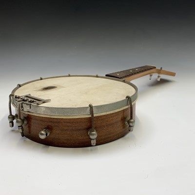 Lot 33 - A small fruitwood four string banjo ukelele,...