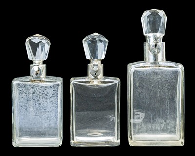 Lot 295 - A matched suite of three Hukin & Heath silver mounted locking decanters.