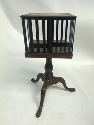 Lot 3017 - A mahogany revolving book stand, with leather...