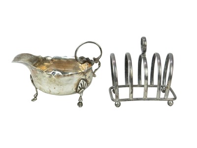 Lot 294 - A silver sauceboat and toastrack.