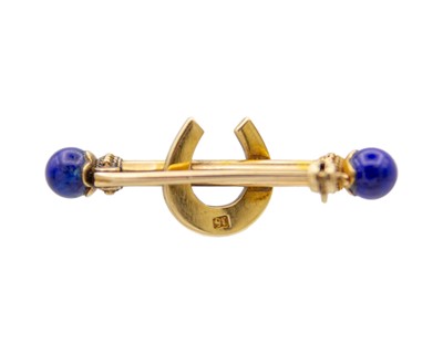 Lot 44 - A Victorian 15k gold horseshoe bar brooch set with lapis lazuli and seed pearls.