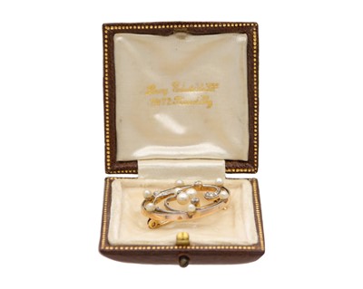 Lot 49 - A Belle Epoque diamond and seed pearl set gold and platinum open-work brooch.