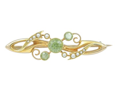 Lot 67 - An Edwardian 15k peridot and seed pearl set brooch.