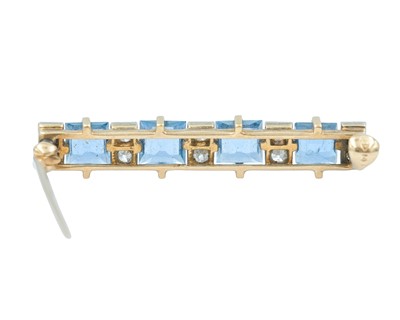 Lot 74 - An Art Deco 14k brooch set with four square, step-cut sapphires and old mine-cut diamonds.