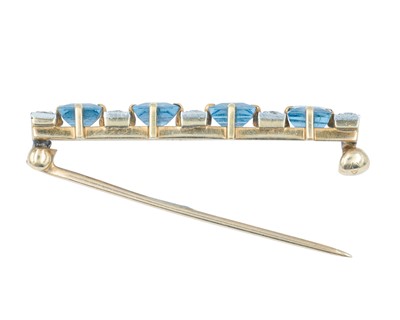 Lot 74 - An Art Deco 14k brooch set with four square, step-cut sapphires and old mine-cut diamonds.